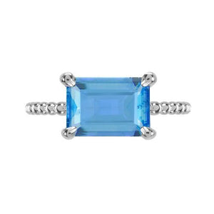 TESSA RING WITH EMERALD CUT BLUE TOPAZ IN WHITE GOLD - ANNIVERSARY & CELEBRATION RINGS